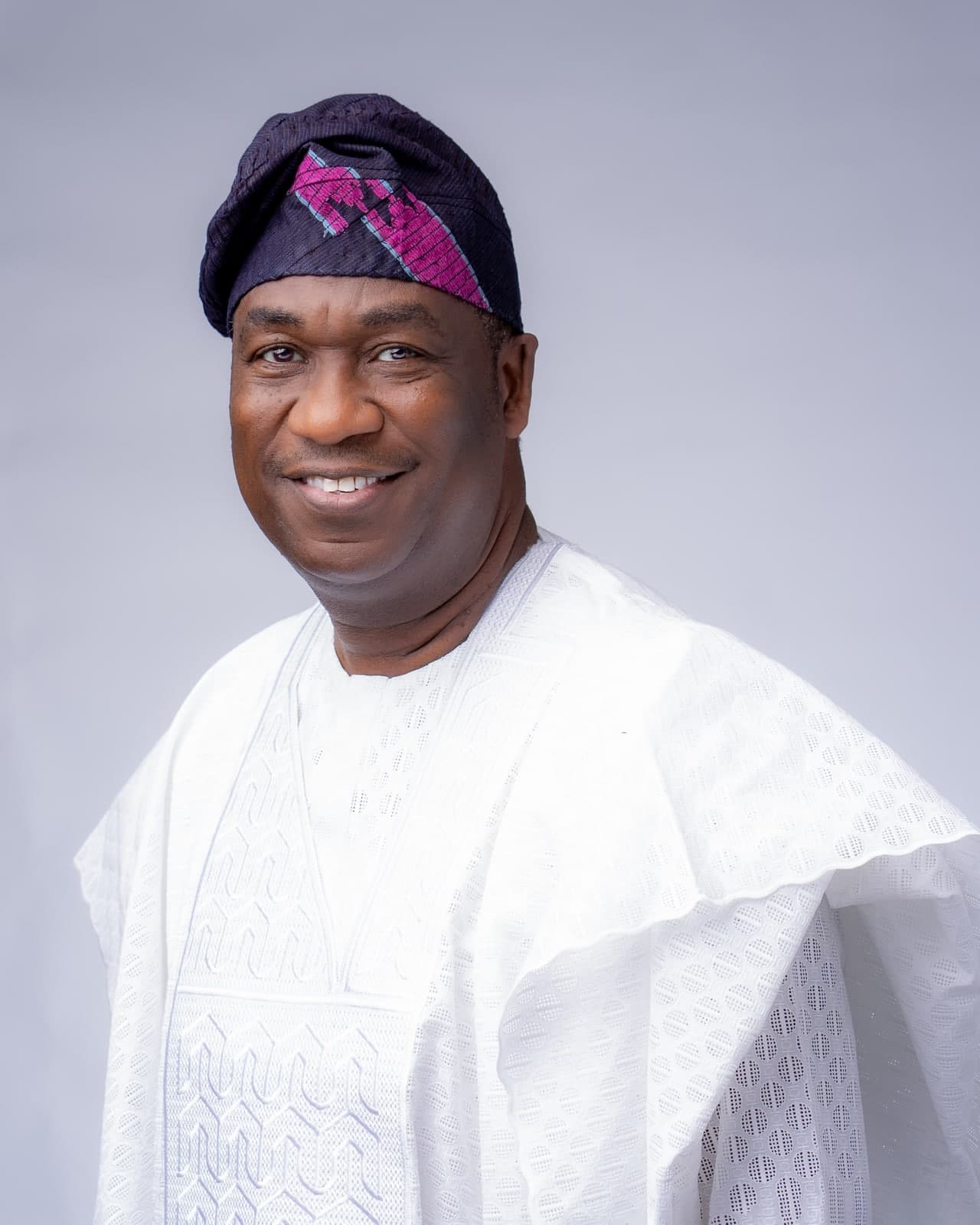 Dr. Kadri Obafemi Hamzat, head and shoulders in a white agbada and a purple and pink patterned cap, turned slightly to one side.